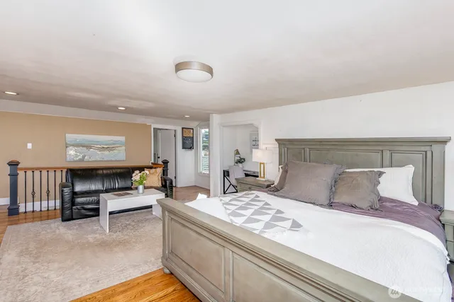 a bedroom with furniture and a large window