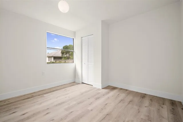 a view of a livingroom with a window and wooden floor