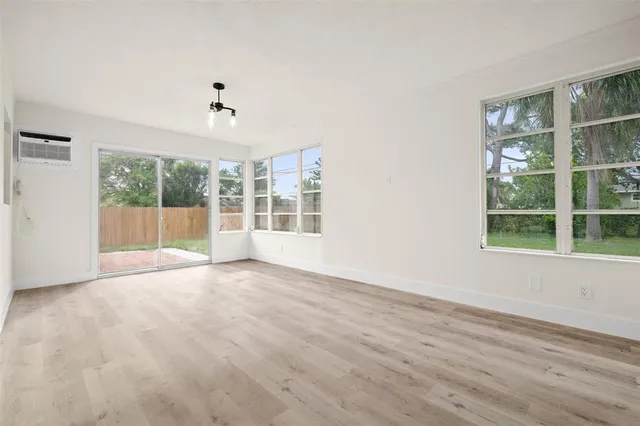 a view of a house with a yard and potted plants