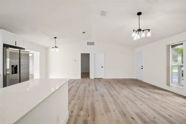 a bathroom with a bathtub shower sink vanity mirror and toilet