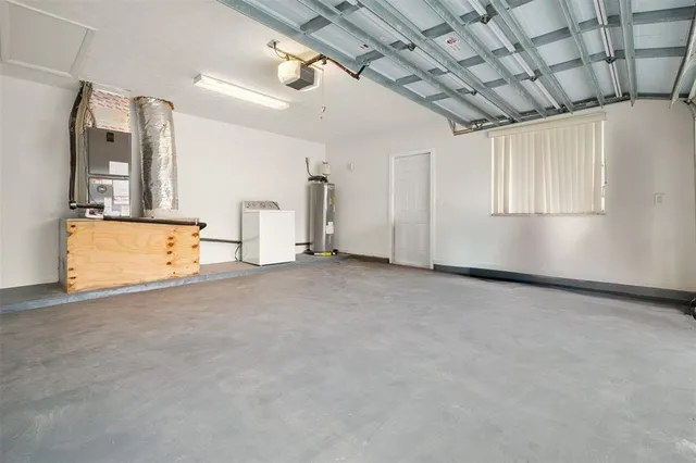 an empty room with wooden floor and window