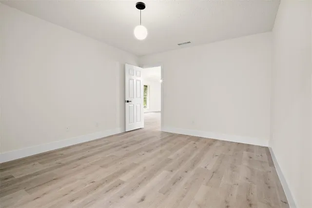 a view of a kitchen with wooden cabinet and windows