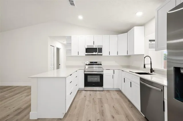 a living room with furniture a flat screen tv and a potted plant