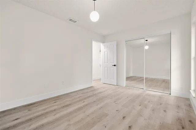a view of a kitchen with a sink and a refrigerator