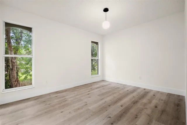 an aerial view of residential houses with outdoor space and street view