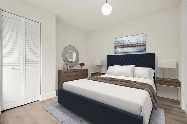 a bedroom with bed and a potted plant