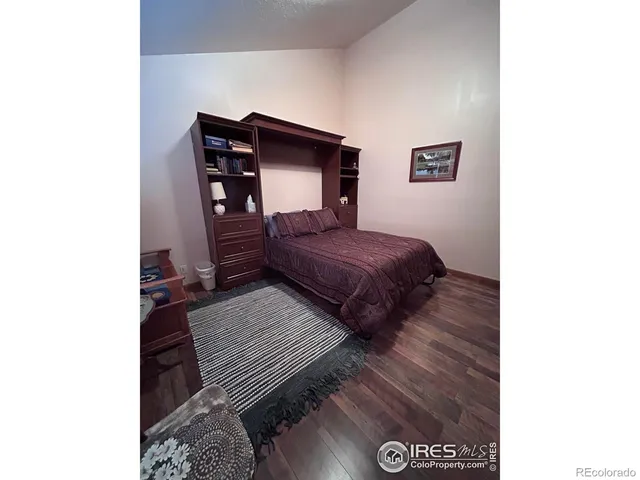 a bedroom with a bed and a desk