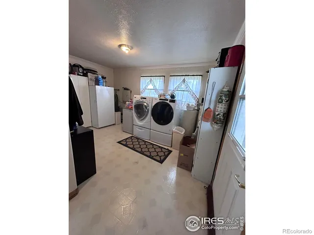 a view of utility room with refrigerator and washer