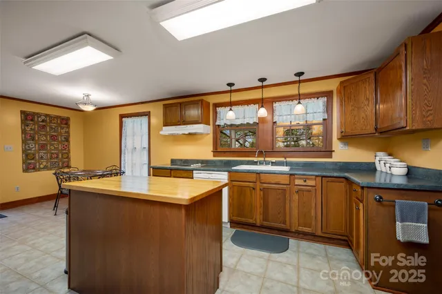 a kitchen with a stove a refrigerator and wooden cabinets