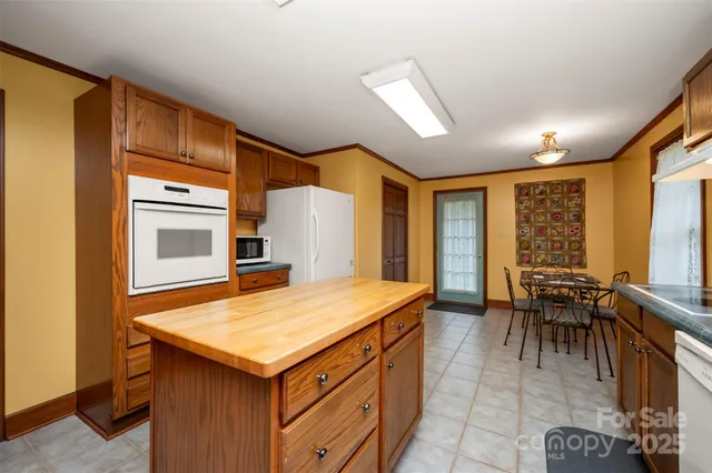 a large kitchen with stainless steel appliances granite countertop a stove a sink dishwasher and a refrigerator