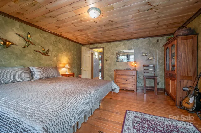 a view of a hallway with wooden floor and closet