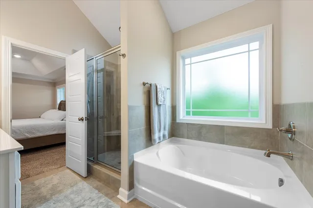 a bathroom with a bathtub and a shower
