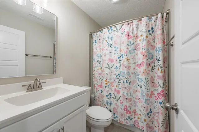 a bathroom with a sink toilet and a mirror