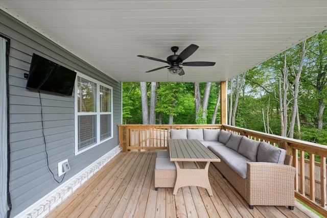 a view of roof deck with furniture and wooden floor