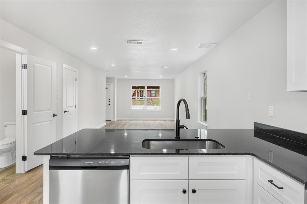 1536 Alexander Avenue, Unit A & B Waco, TX 76708 - Photo 19 of 31 The kitchen features a black countertop with an integrated sink and a matte black faucet