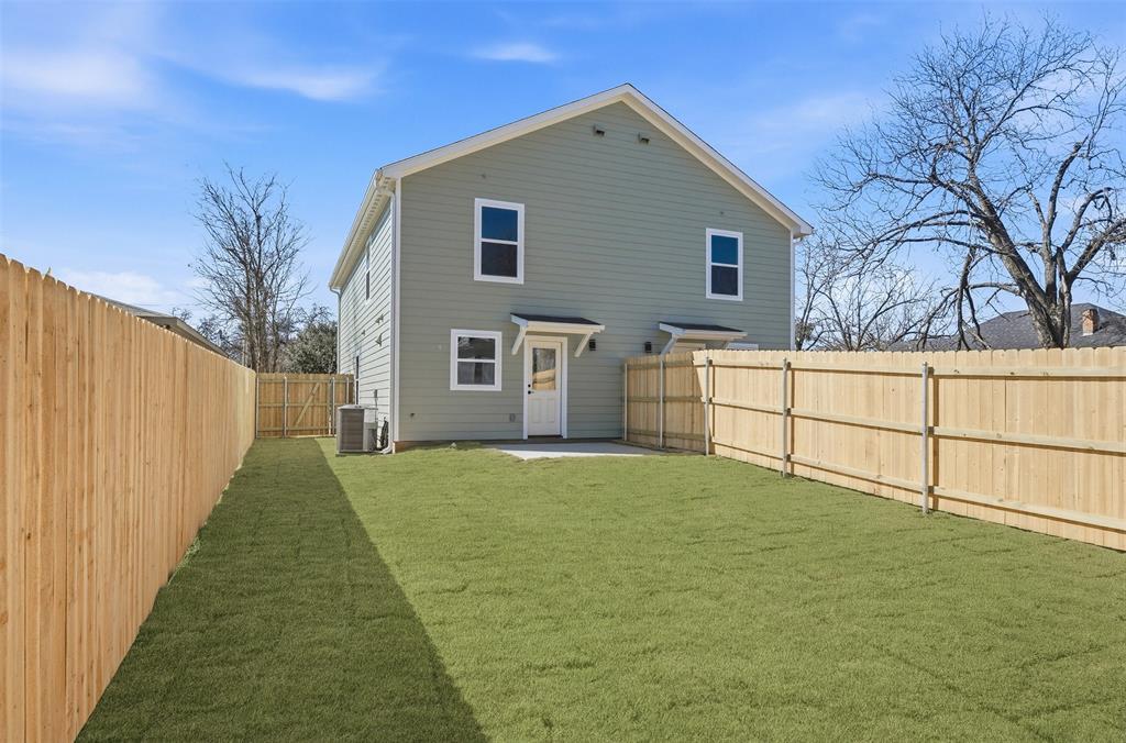 1536 Alexander Avenue, Unit A & B Waco, TX 76708 - Photo 9 of 31 The property features a private backyard with a well-maintained lawn and new wooden fencing