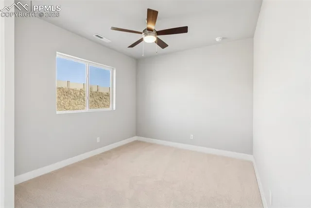 a view of a house with wooden fence