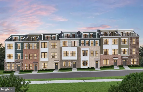 a front view of a residential apartment building with a yard