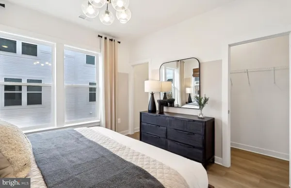 a bedroom with a bed and a dresser