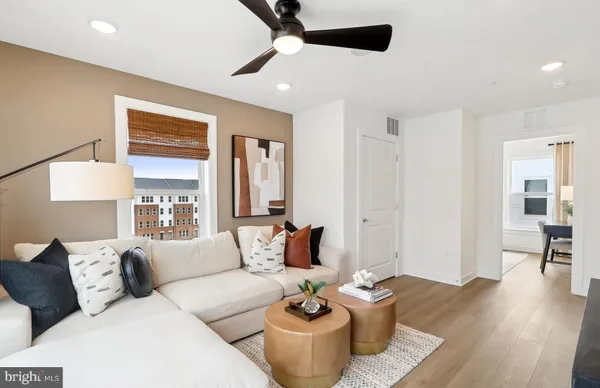 a living room with furniture and wooden floor