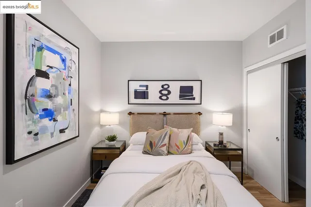 a bedroom with bed and wall painting on the wall