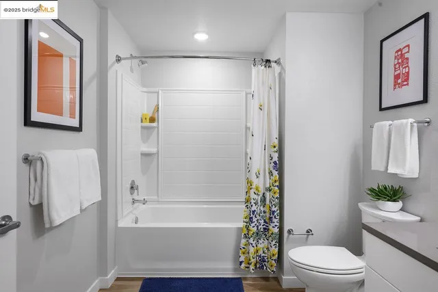 a bathroom with a shower a toilet and a shower