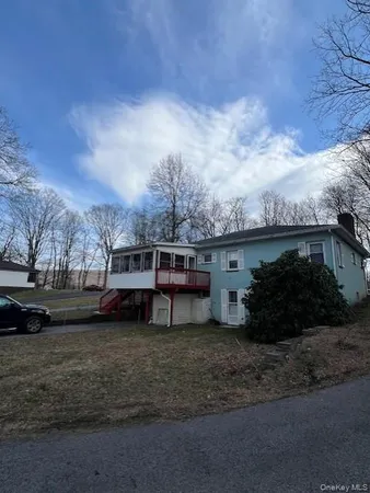 a view of a house with a yard and roof