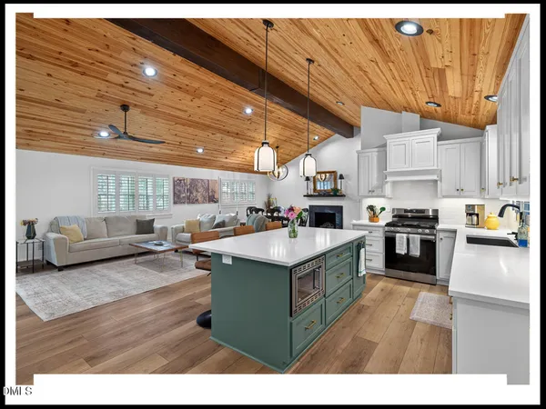 a kitchen with stainless steel appliances granite countertop a stove and a refrigerator