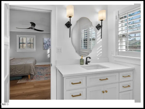 a bathroom with a sink a mirror and a window