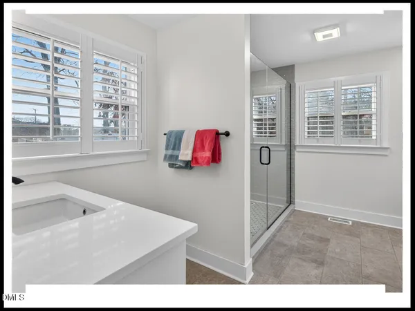 a bathroom with a tub sink and mirror