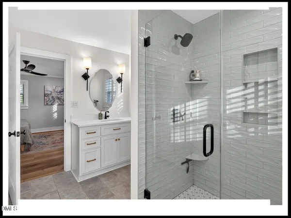a bathroom with a shower sink and mirror