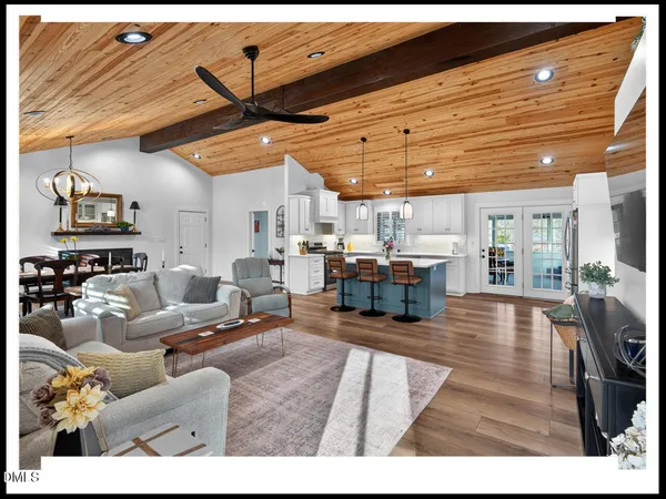 a living room with lots of furniture and kitchen view