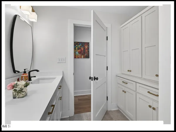 a bathroom with a sink vanity and a mirror