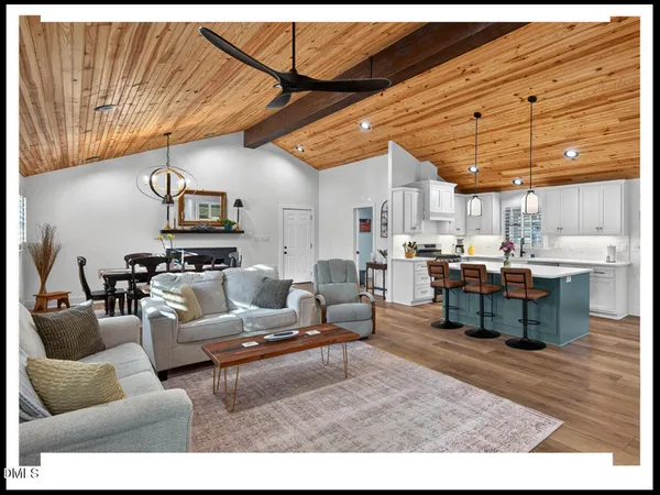 a living room with lots of furniture and kitchen view