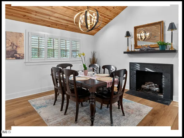 a dining room with furniture and a fireplace