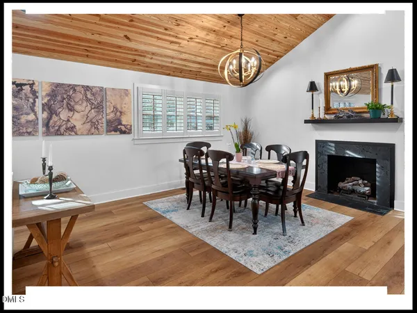 a view of a dining room with furniture and chandelier