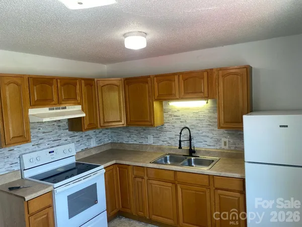 a kitchen with a sink and wooden cabinets