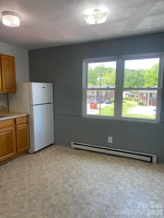 a kitchen with refrigerator and window