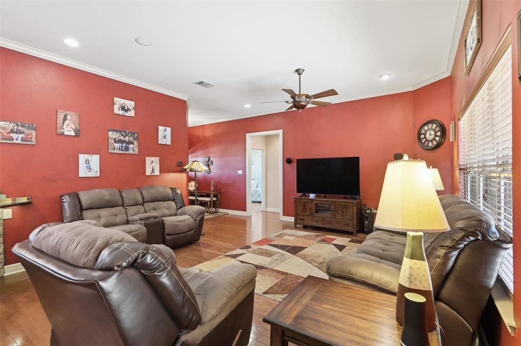 207 Dennis Road Lipan, TX 76462 - Photo 11 of 40 Living area with wood-finish flooring, recessed lighting, crown molding, and a ceiling fan