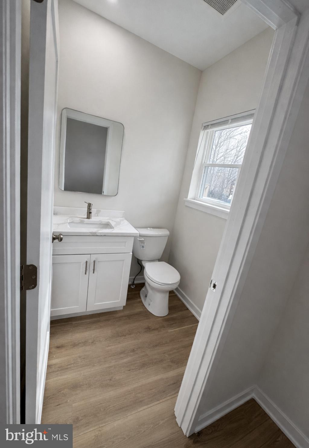415 Almonesson Road Blackwood, NJ 08012 - Photo 3 of 26 a bathroom with a toilet sink mirror and vanity