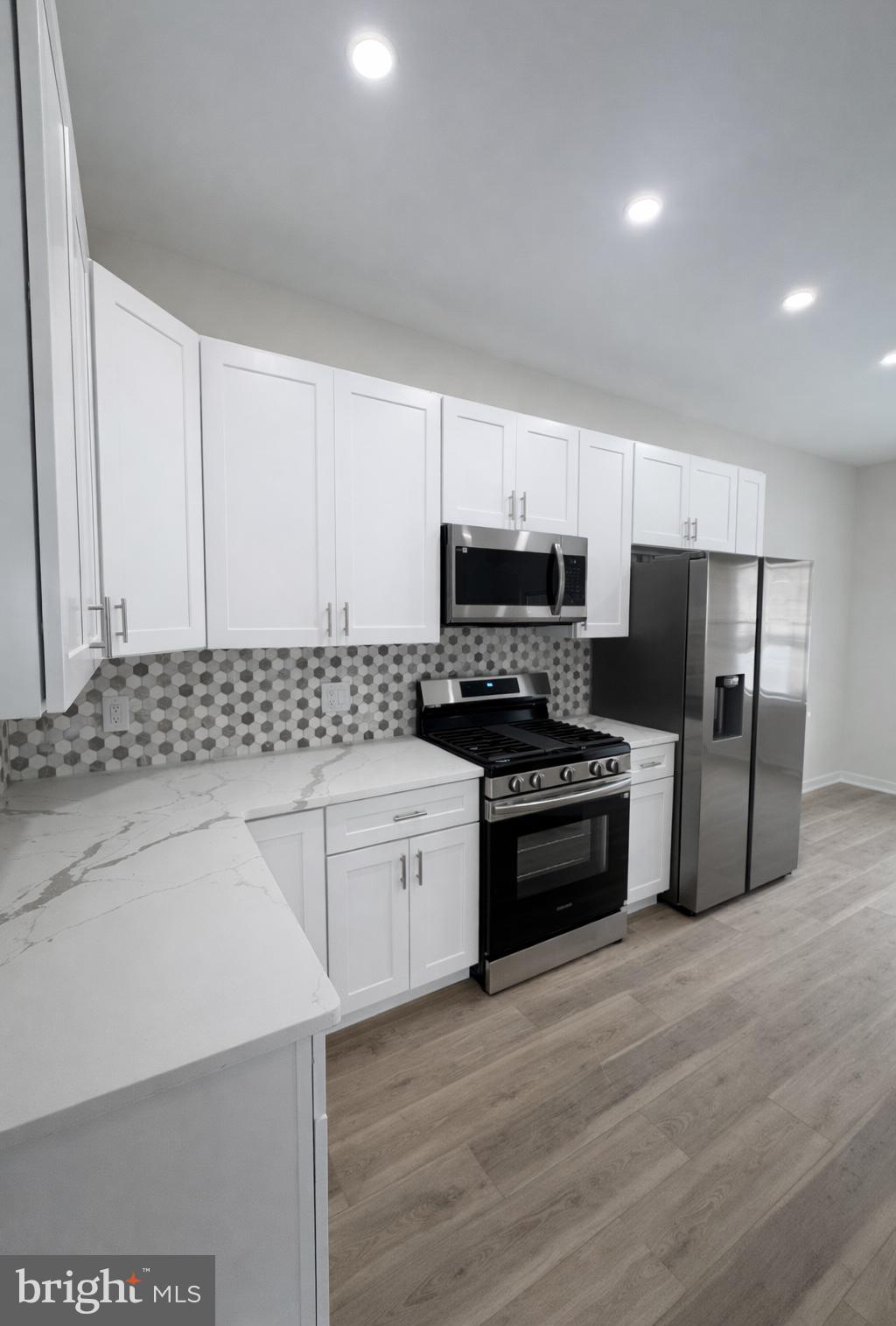 415 Almonesson Road Blackwood, NJ 08012 - Photo 7 of 26 a kitchen with stainless steel appliances granite countertop a stove a sink and a refrigerator