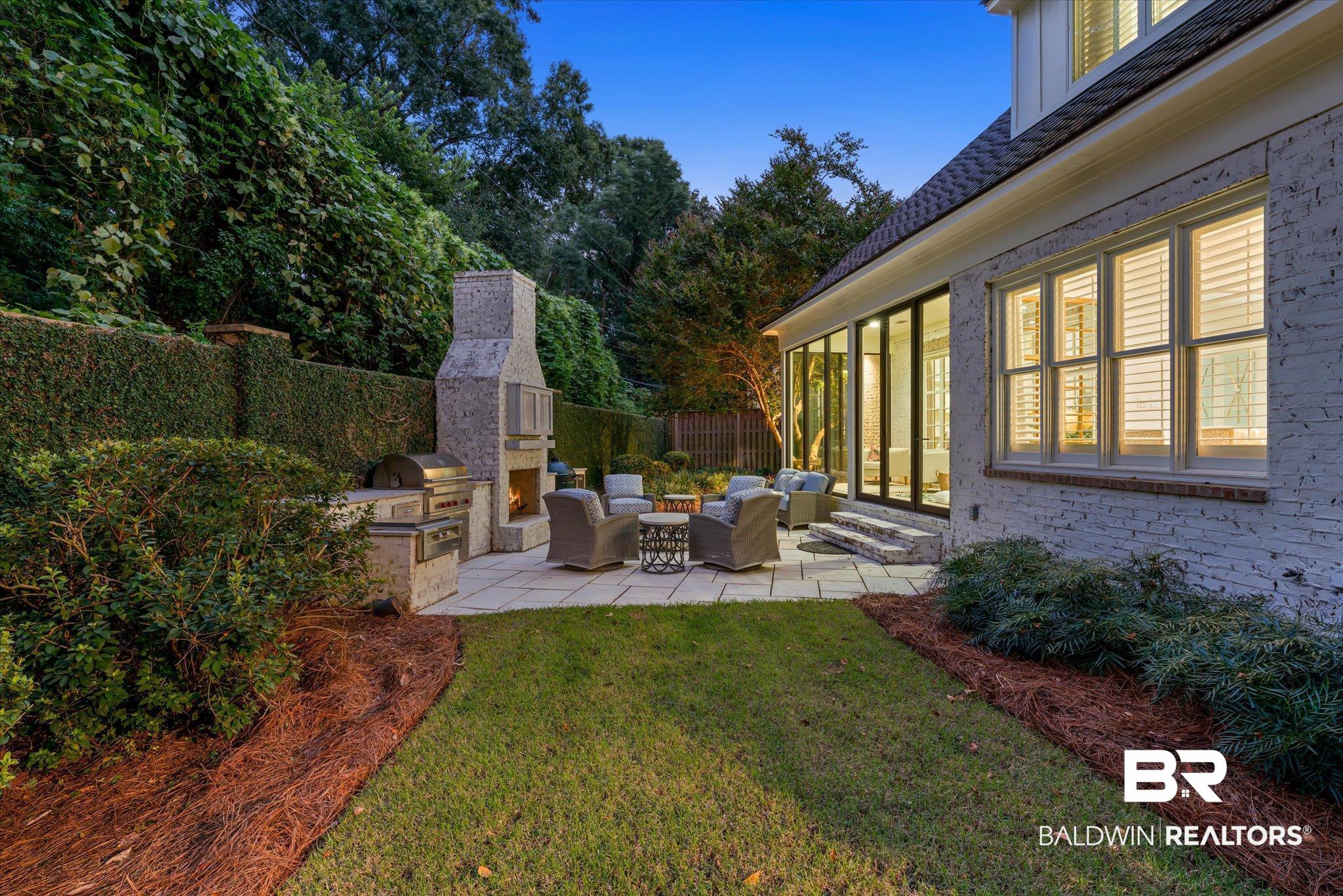320 Long Court Mobile, AL 36608 - Photo 56 of 61 View of yard with area for grilling, an outdoor fireplace, and a patio