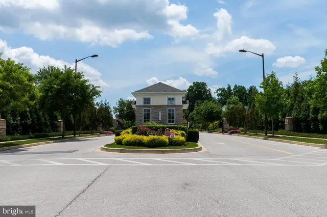 a front view of a house with yard and parking