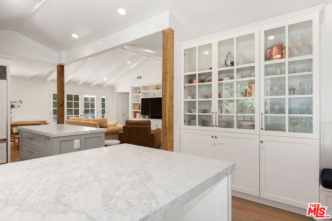 3404 Merrimac Road Los Angeles, CA 90049 - Photo 12 of 29 a large white kitchen with sink and dishwasher next to a large window