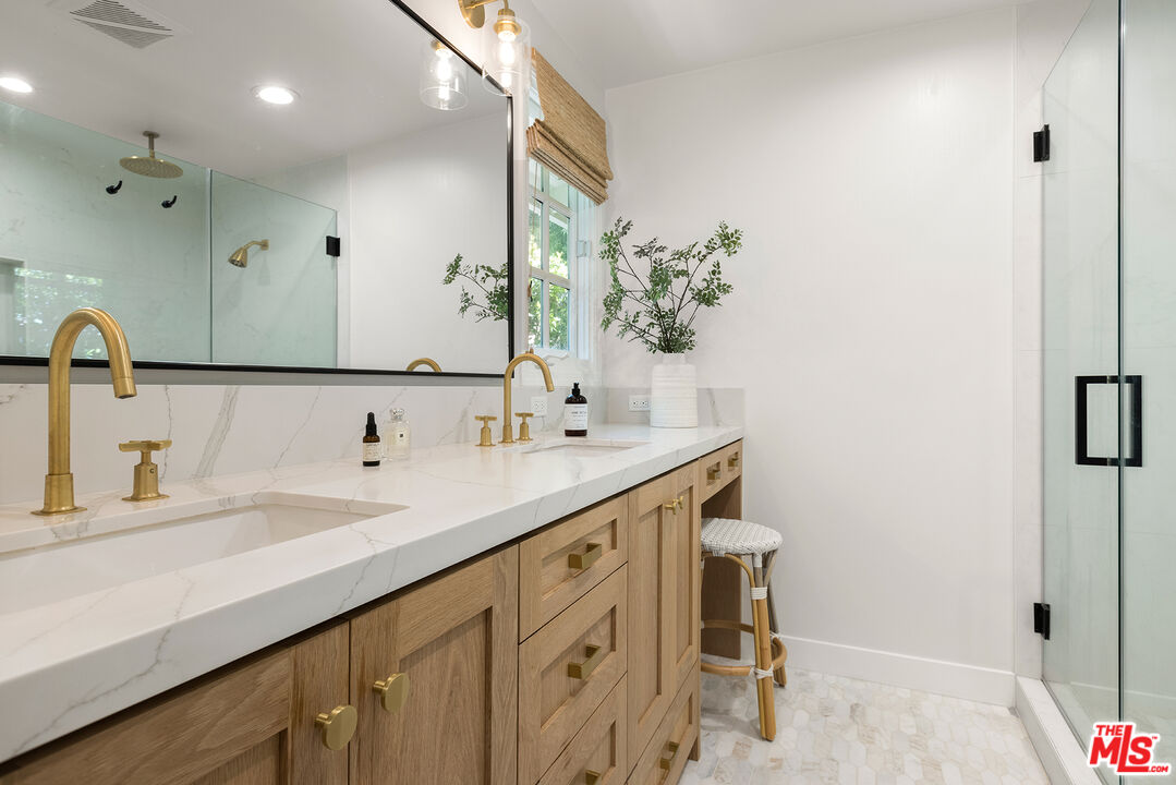 3404 Merrimac Road Los Angeles, CA 90049 - Photo 16 of 29 a bathroom with a double vanity sink and a mirror