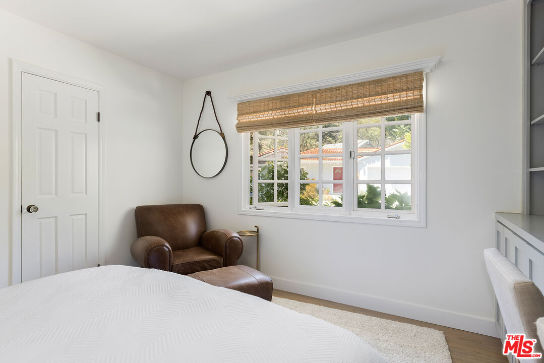 3404 Merrimac Road Los Angeles, CA 90049 - Photo 19 of 29 a bedroom with a bed and wooden floor