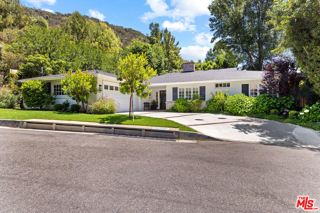 3404 Merrimac Road Los Angeles, CA 90049 - Photo 2 of 29 a view of house with a yard and palm trees
