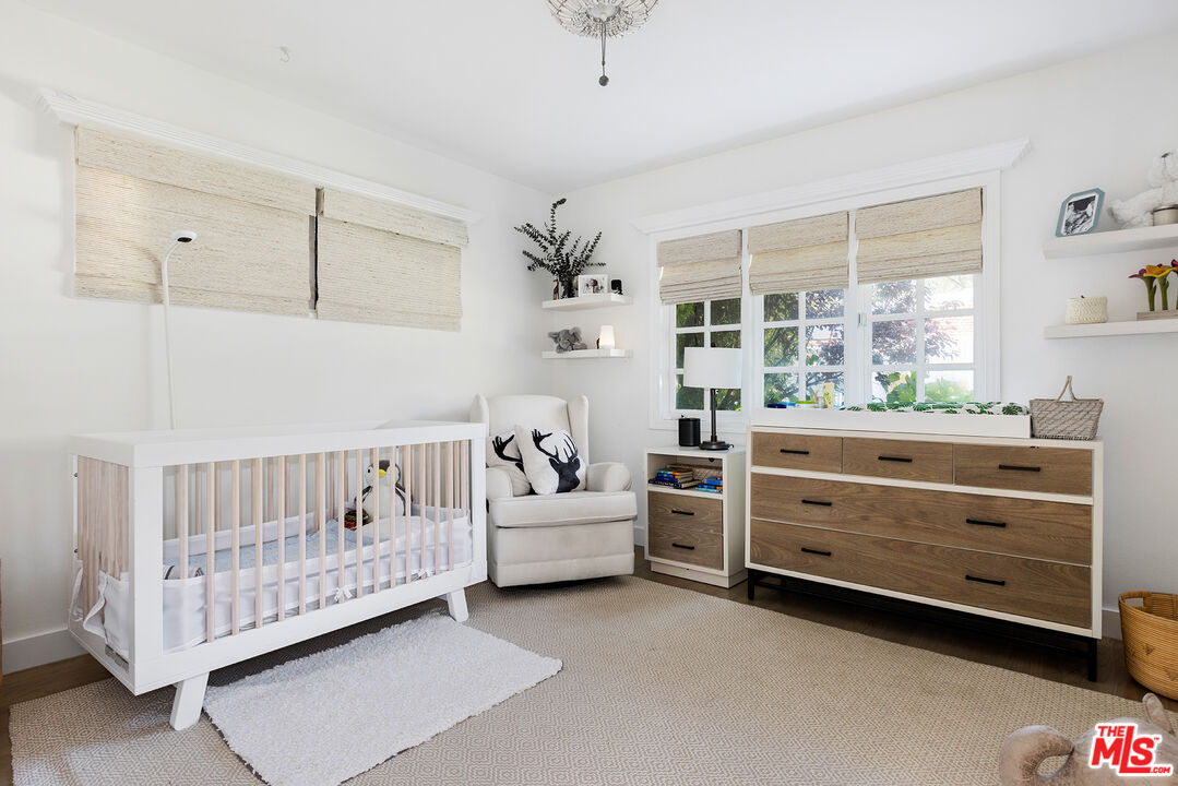 3404 Merrimac Road Los Angeles, CA 90049 - Photo 22 of 29 a bedroom with a bed and a window
