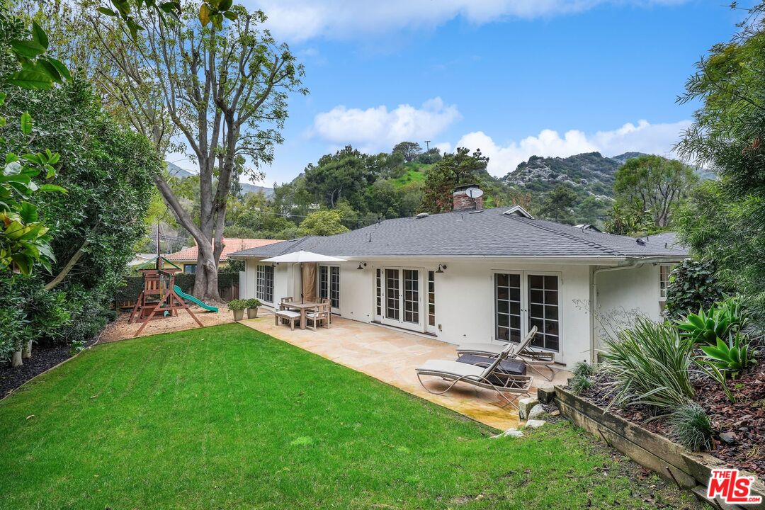 3404 Merrimac Road Los Angeles, CA 90049 - Photo 26 of 29 a view of a house with a backyard and a patio