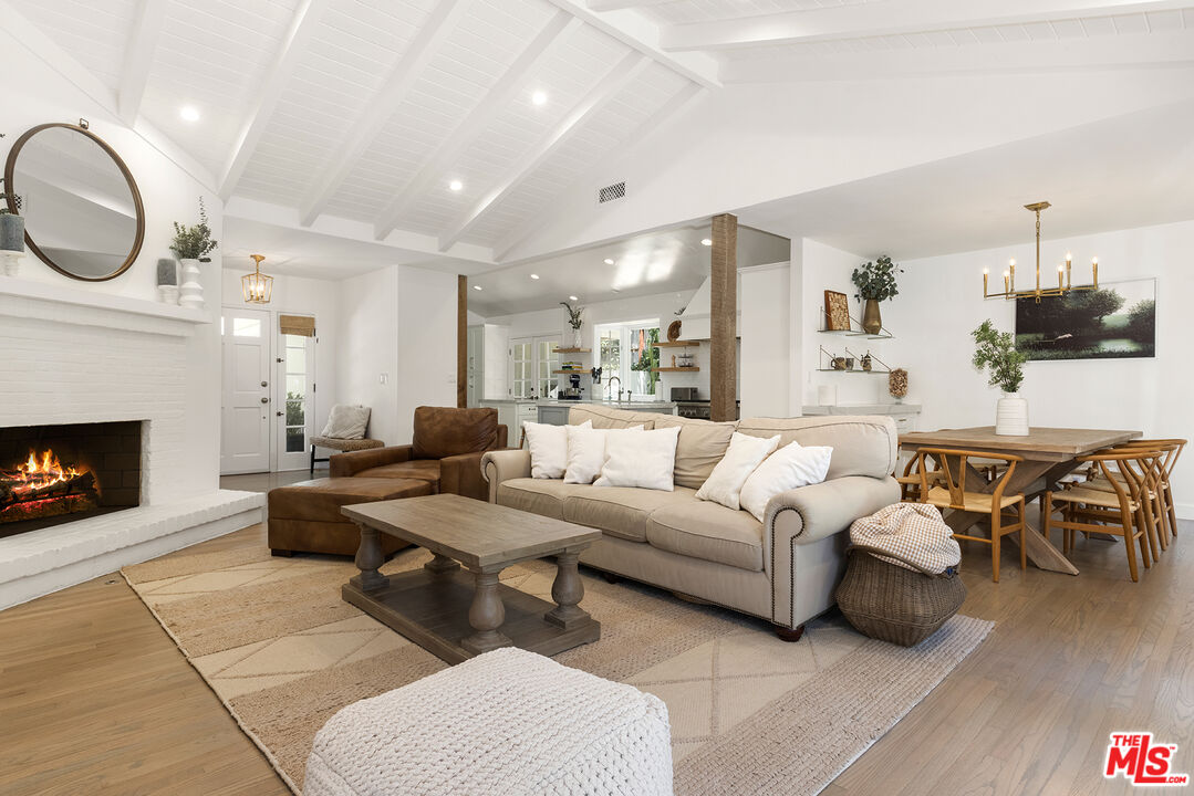 3404 Merrimac Road Los Angeles, CA 90049 - Photo 6 of 29 a living room with furniture a fireplace and wooden floor